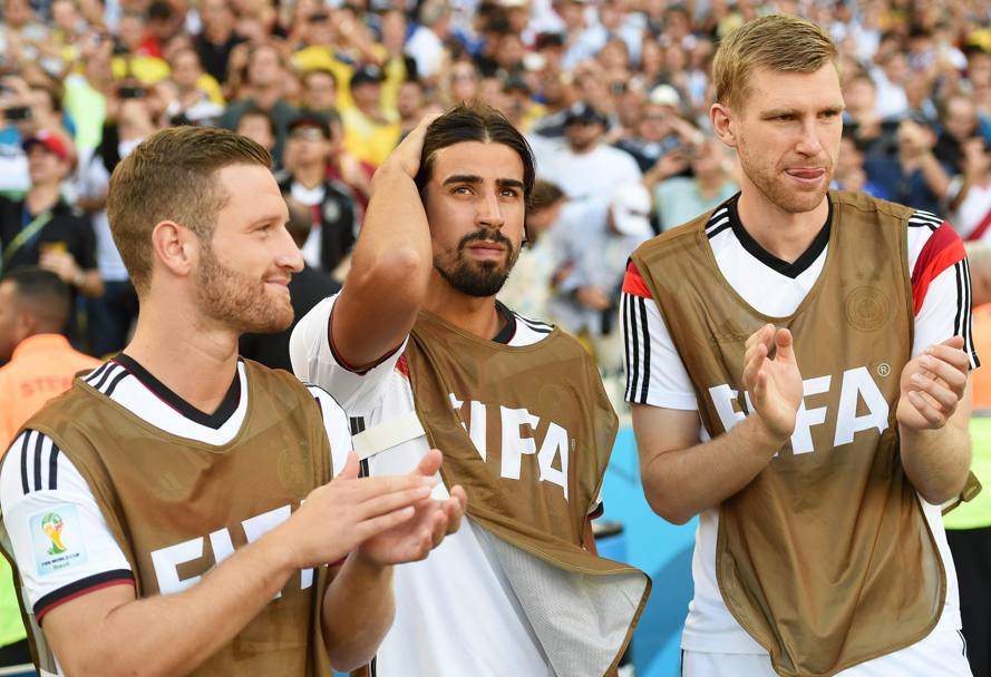 Sami Khedira sembra sconsolato, mentre i suoi compagni Mertesacker e Mustafi applaudono: il centrocampista di origine turca ha avuto un problema nel riscaldamento e ha dovuto saltare la finale. Epa